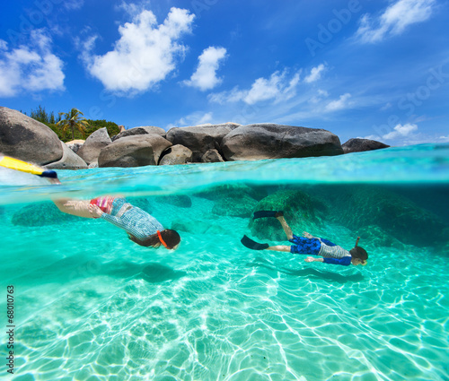 Family snorkeling in tropical water