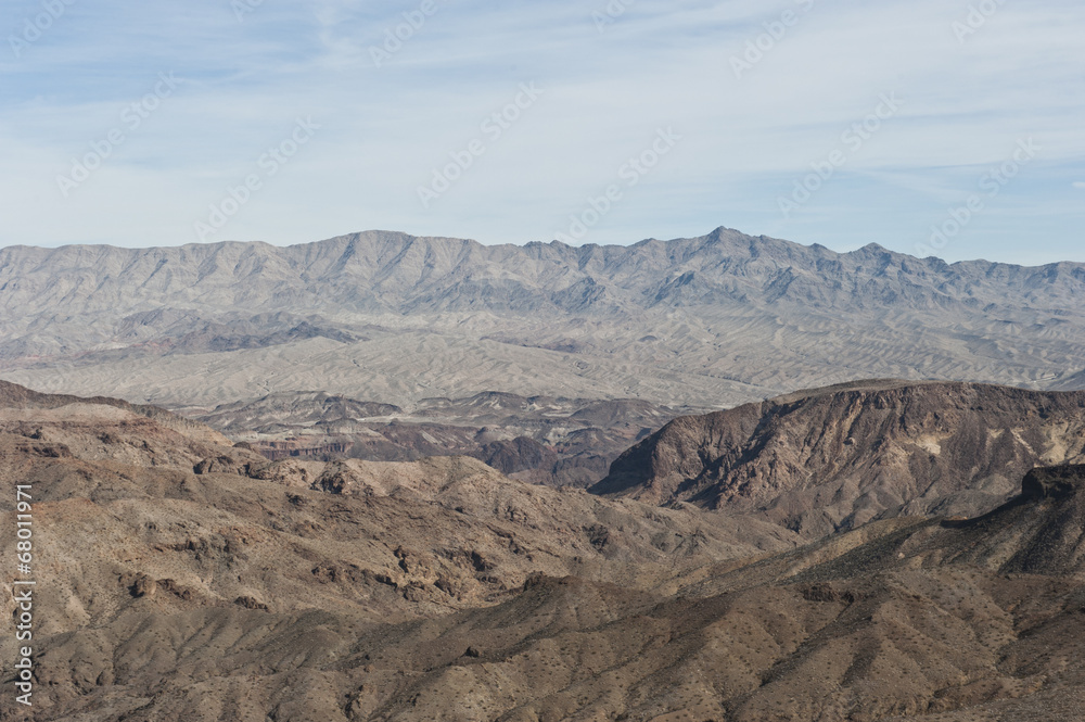 Naklejka premium A dry desert view on a sunny day from a helicopter.