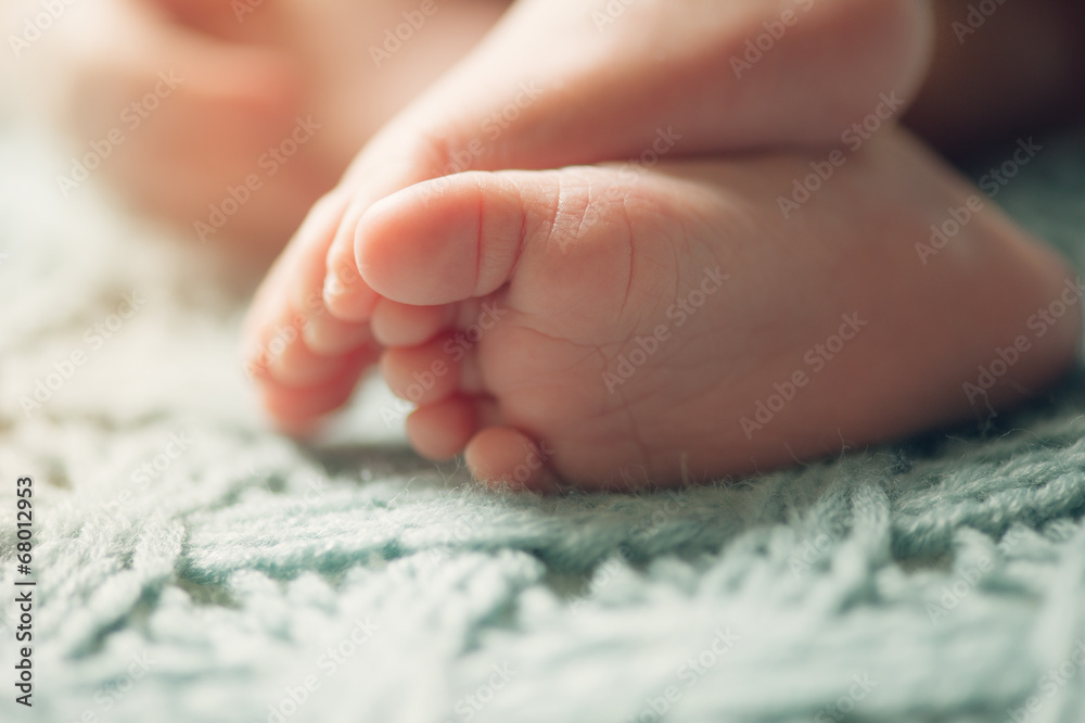 Small delicate little feet of newborn