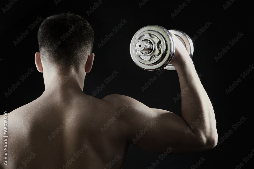 Handsome young muscular sportsman execute exercise with Handsome young muscular sportsman execute exercise with