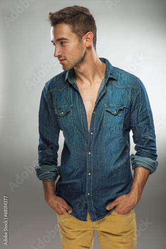 Handsome man in fashionable dress posing in jeans © Zsolnai Gergely
