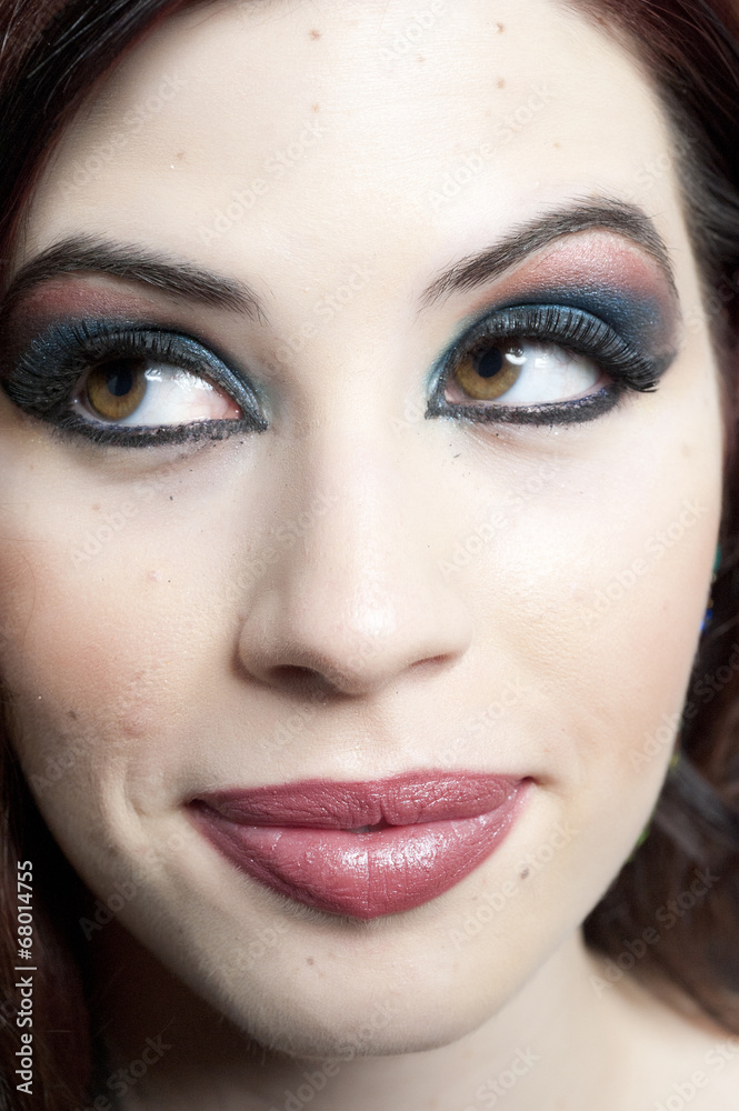 A closeup on the model's makeup in a studio. A closeup on the model's makeup in a studio.