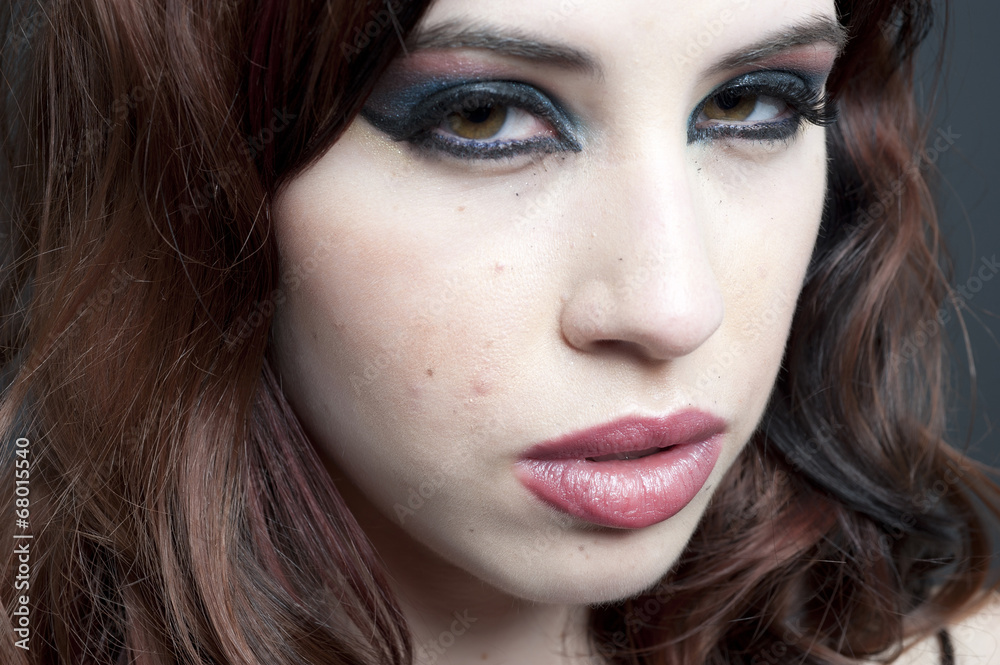 A closeup of a female model in a studio. A closeup of a female model in a studio.