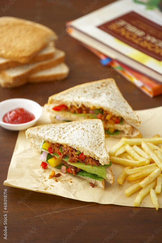 meat sandwich and potato fried on paper meat sandwich and potato fried on paper