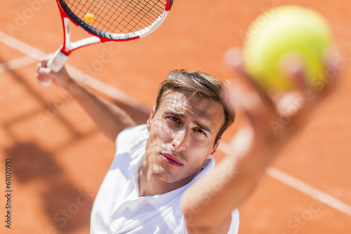 Young man playing tennis photo