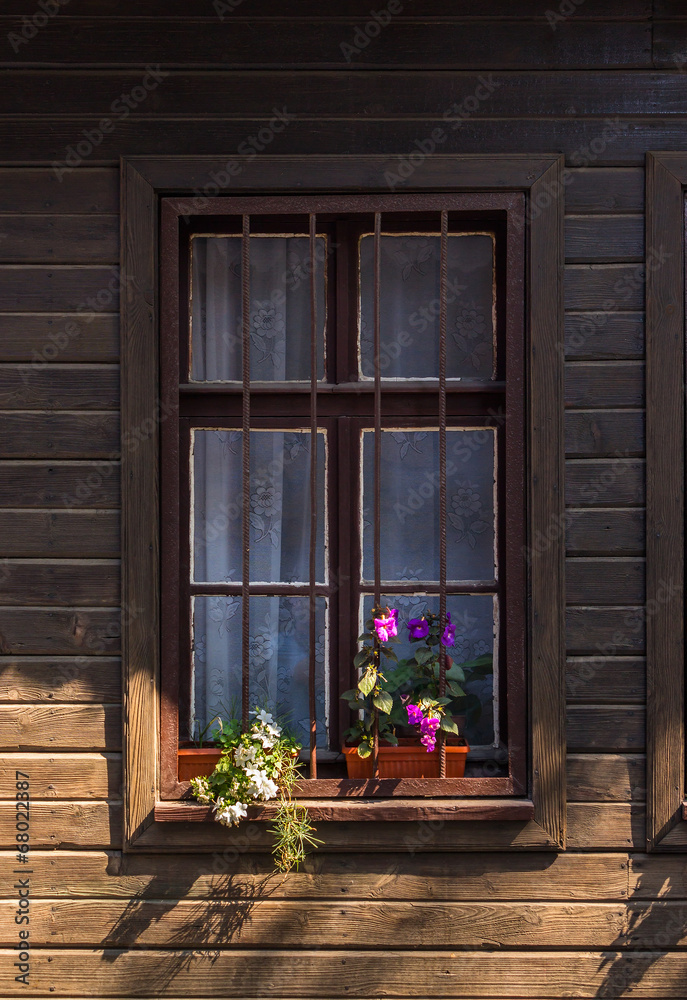 window with grate and flowers