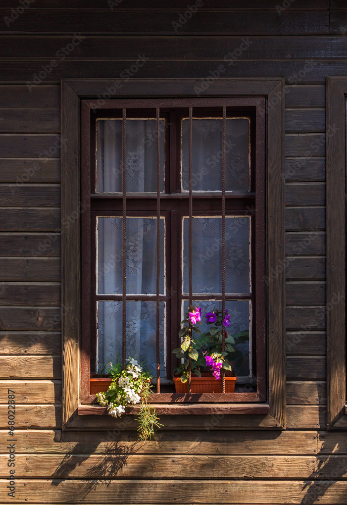 Obraz premium window with grate and flowers