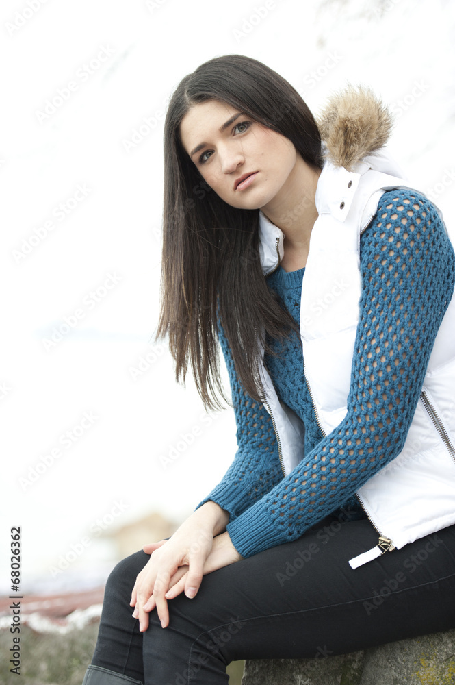 A fashionable young brunette on a cloudy day wearing winter apparel. A fashionable young brunette on a cloudy day wearing winter apparel.