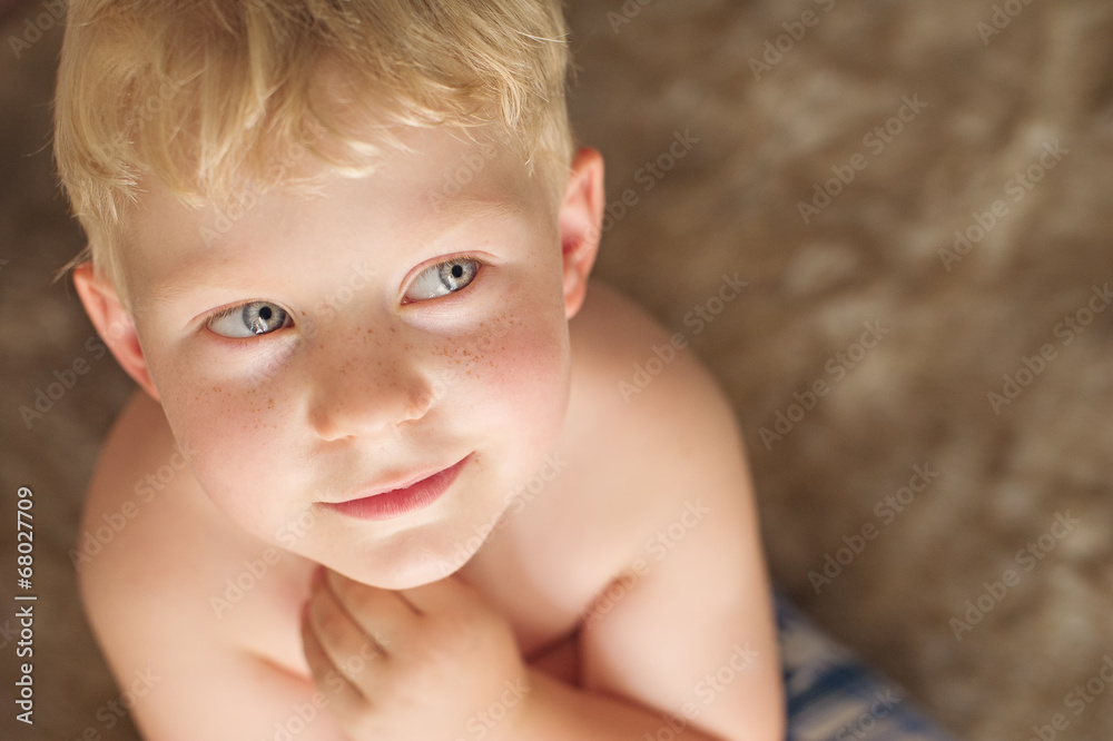 Cute young boy looking up with blond hair Cute young boy looking up with blond hair