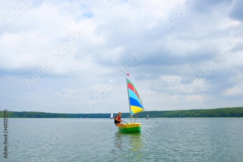 Sailing, Girl flows in a sailboat on the lake