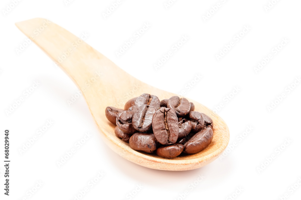 Wooden spoon with coffee beans isolated on white background. Wooden spoon with coffee beans isolated on white background.