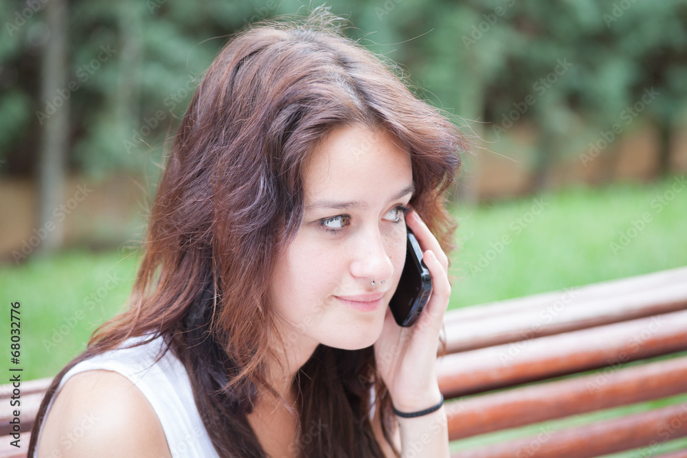 Clouse up of an anxious girl talking on smart phone. Clouse up of an anxious girl talking on smart phone.