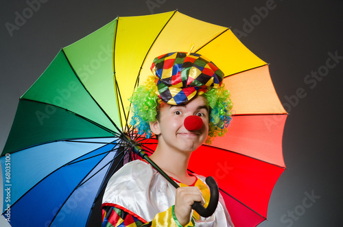 Funny clown with colourful umbrella