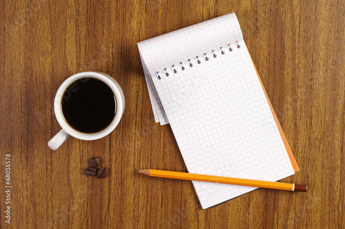 Cup of coffee and notepad