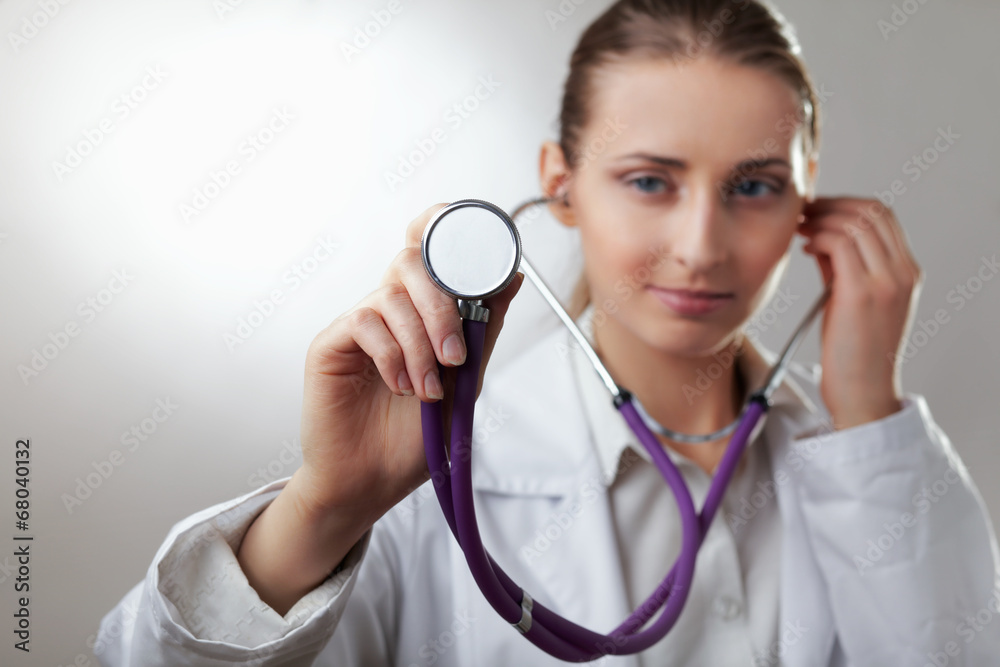 Close-up of female doctor using stethoscope Close-up of female doctor using stethoscope