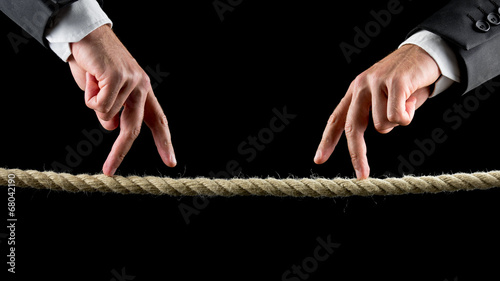 Fotografia Two male hands making the walking sign on a rope