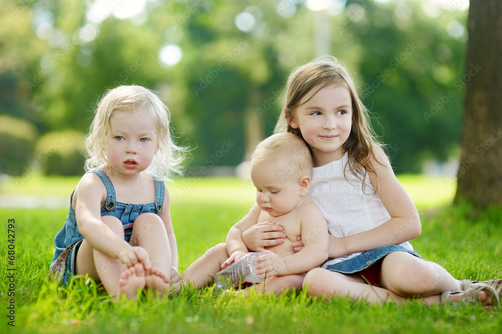 Three adorable little kids having fun outdoors Three adorable little kids having fun outdoors