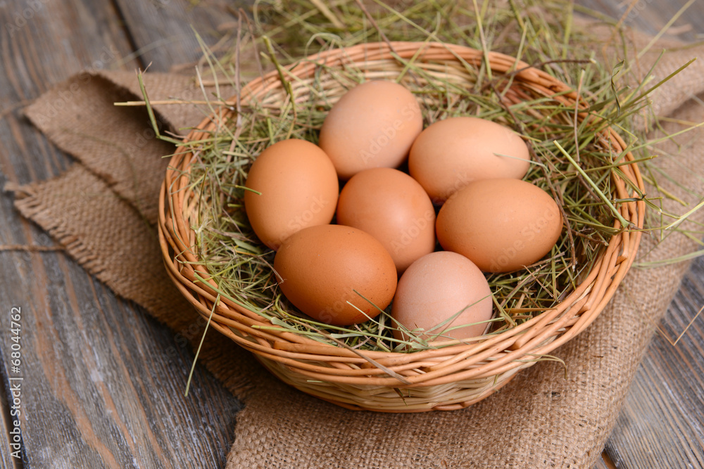 Eggs in wicker basket on table close-up Eggs in wicker basket on table close-up