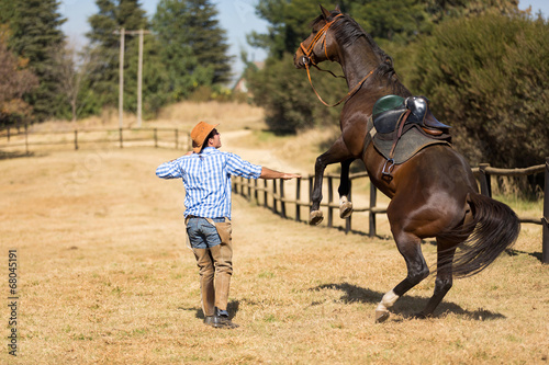 cowboy taming a loosing racing horse © michaeljung
