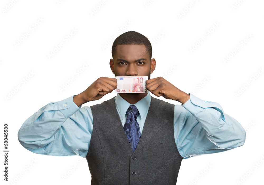 Serious bribery man covers his mouth with euro bill currency Serious bribery man covers his mouth with euro bill currency