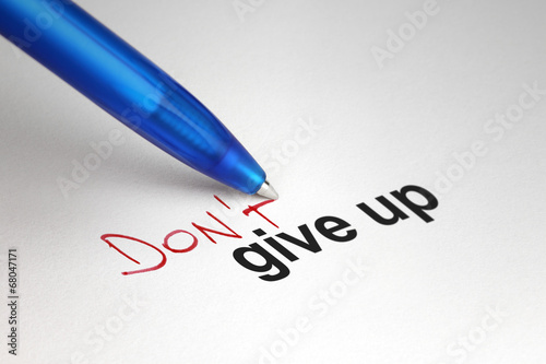 Don't give up. Written on white paper photo