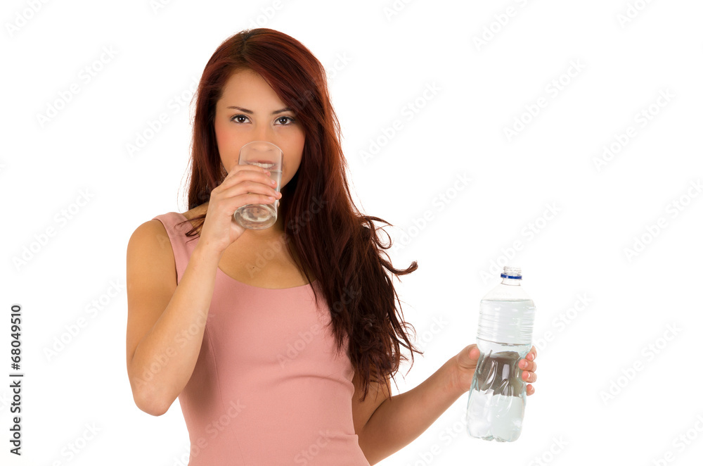 Happy latin young girl drinking water side view Happy latin young girl drinking water side view