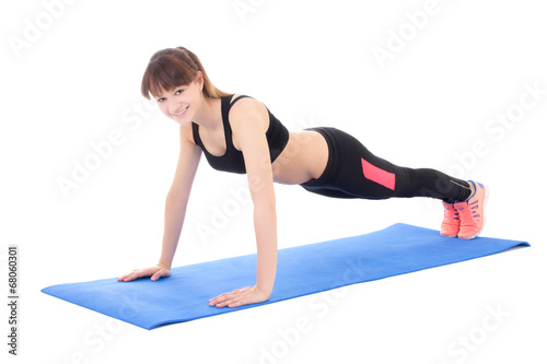 young woman doing push up exercise isolated on white