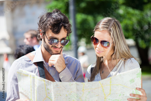 Photography Couple of tourists reading a map