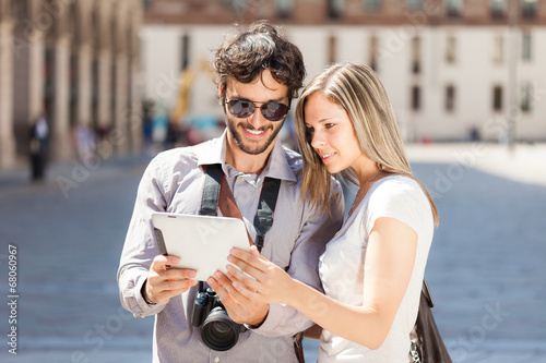 Tourists using a digital tablet © Minerva Studio