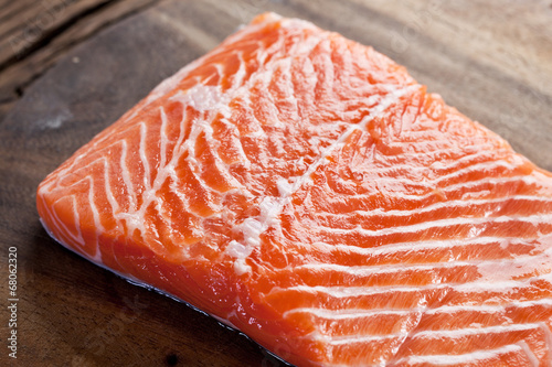 Salmon filet on a wooden carving board.