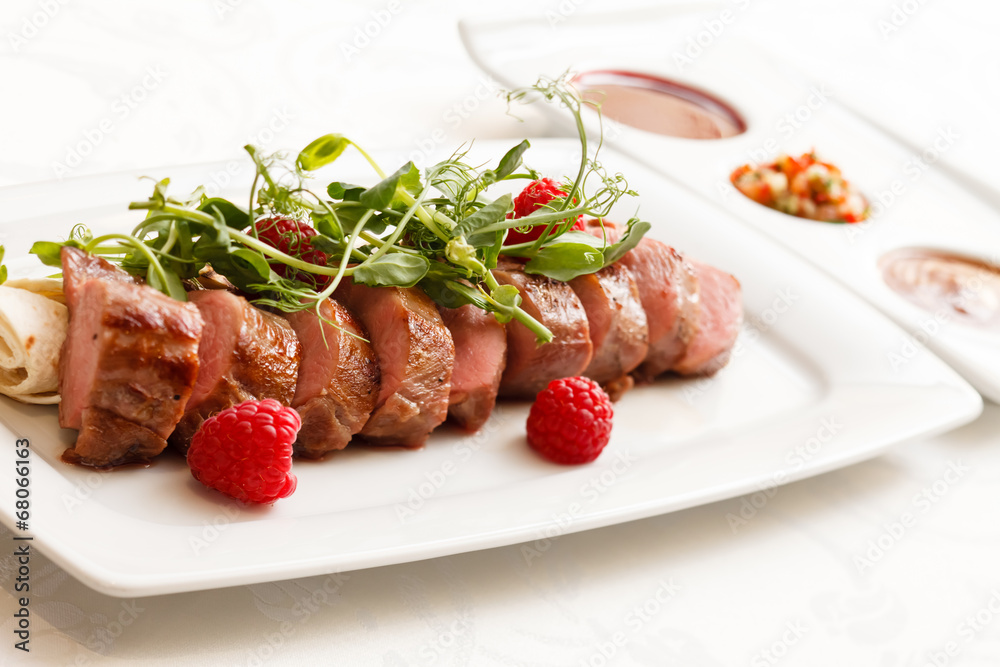 grilled duck breast covered with sweet red fruit sauce grilled duck breast covered with sweet red fruit sauce