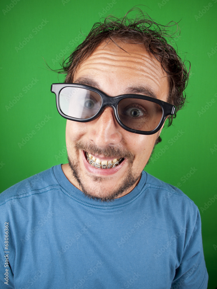 Thirty year old man with 3d glasses is watching a funny movie Thirty year old man with 3d glasses is watching a funny movie
