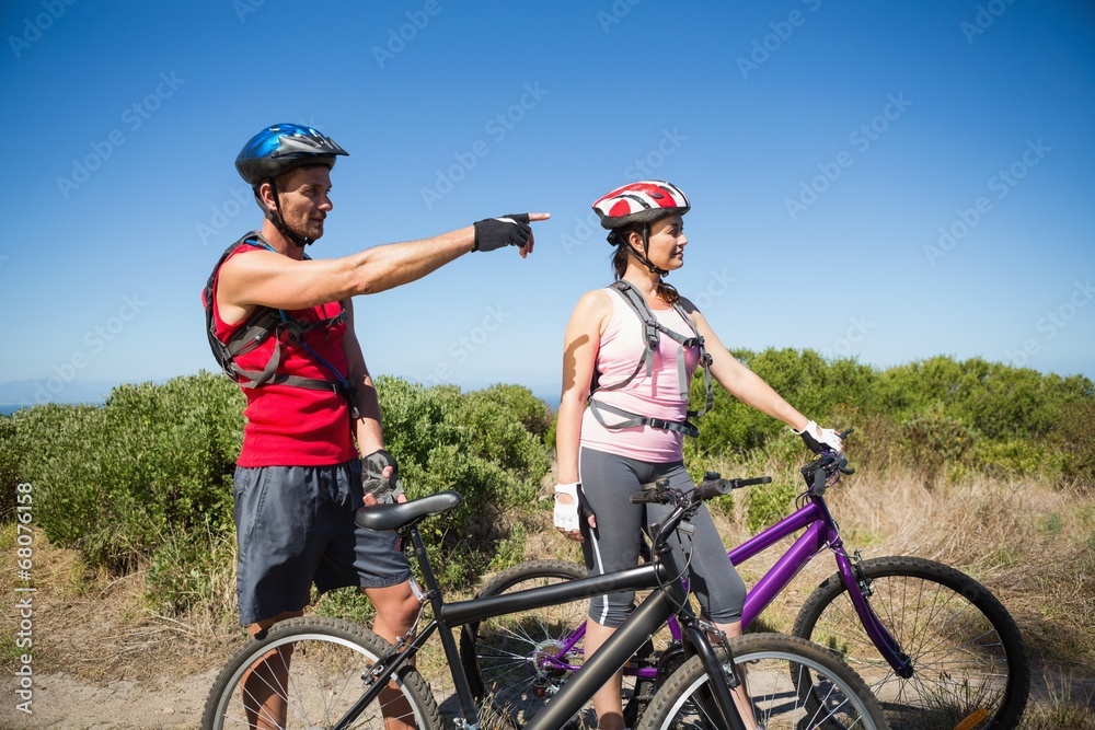 Active couple cycling in the countryside looking ahead