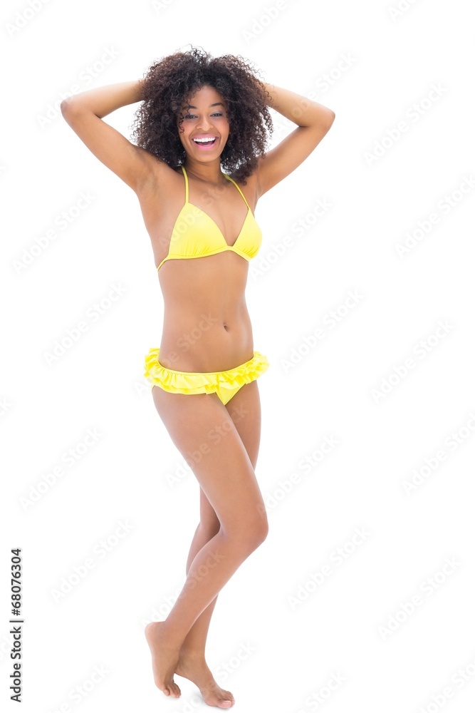 Fit girl in yellow bikini smiling at camera Fit girl in yellow bikini smiling at camera
