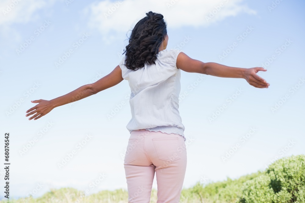 Casual pretty woman standing with arms out Casual pretty woman standing with arms out