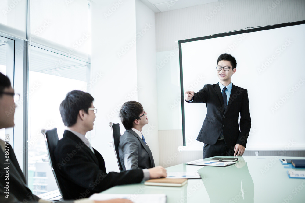 businessman giving a presentation to his colleagues businessman giving a presentation to his colleagues