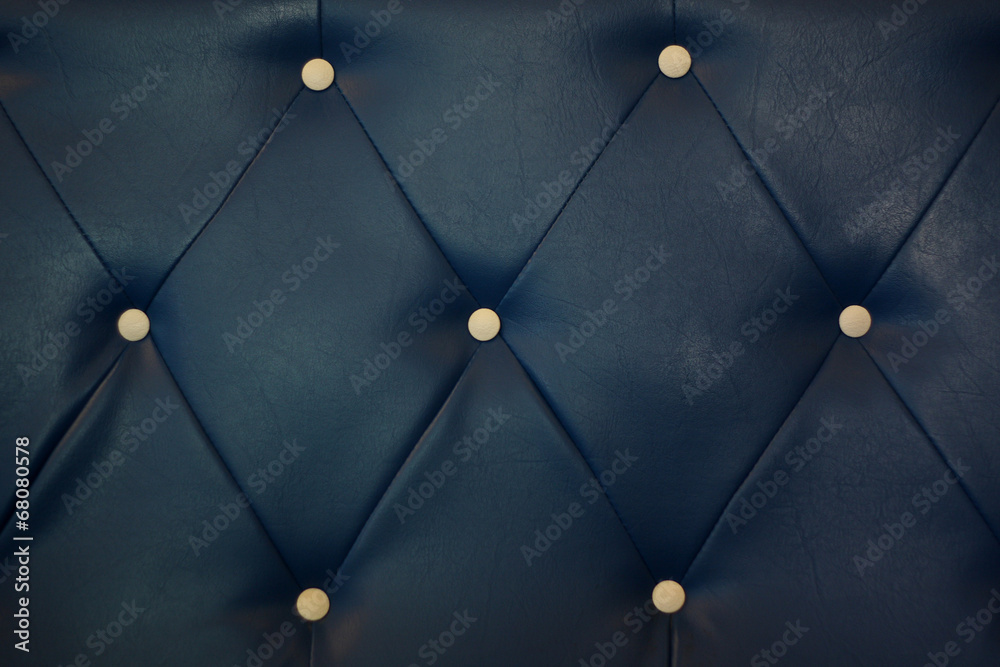 white bottoned on blue leather pattern background