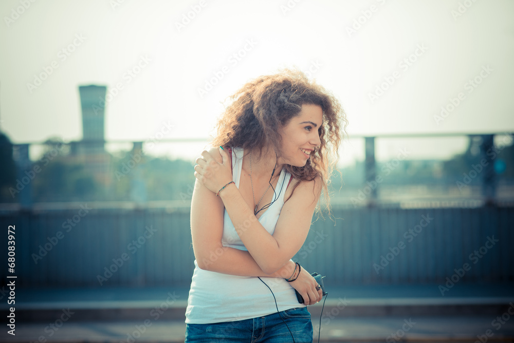Obraz premium young beautiful long curly hair hipster woman listening music