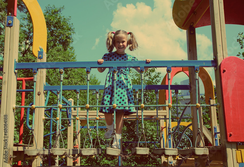 little girl on playground - vintage retro style