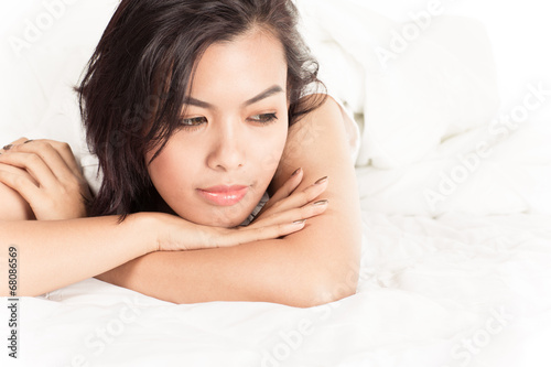 Portrait of a beautiful young woman in bed