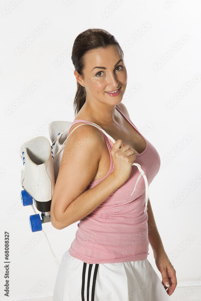 Female skater carrying quad boots over her shoulder Female skater carrying quad boots over her shoulder