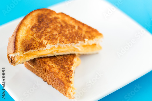Grilled Cheese on white plate with blue background