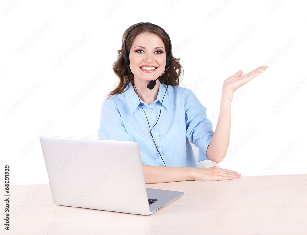 Young woman with headset sitting at table with notebook in room Young woman with headset sitting at table with notebook in room