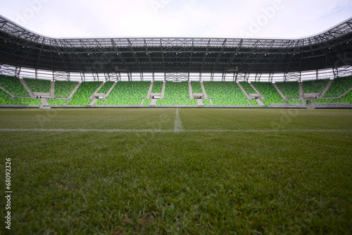 Empty green bleachers at stadium.