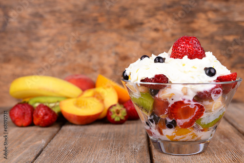 Fototapeta Naklejka Na Ścianę i Meble -  Fresh fruits salad with ice cream in bowl and fruits