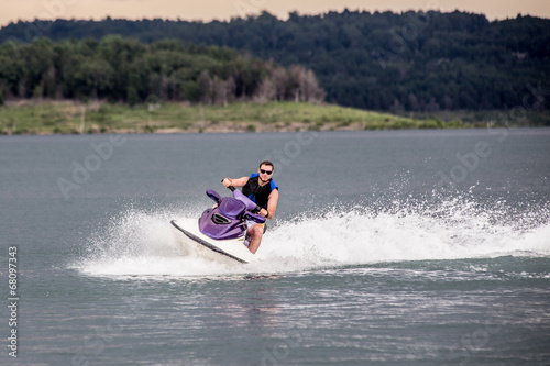 Young Man piloting a personal water craft photo