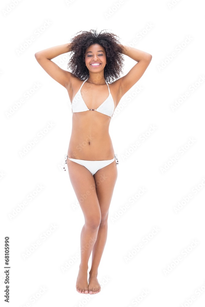 Fit girl in white bikini smiling at camera Fit girl in white bikini smiling at camera