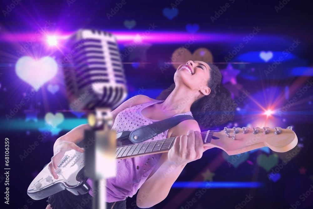 Fototapeta premium Composite image of pretty girl playing guitar