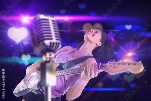 Composite image of pretty girl playing guitar