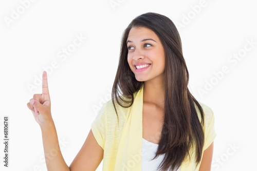 Happy casual woman pointing up